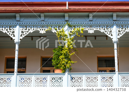 Traditional house veranda with ornate white woodwork Traditional house veranda with ornate white woodwork 140432738