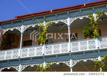 Historic house balcony with ornate white railings Historic house balcony with ornate white railings 140432751