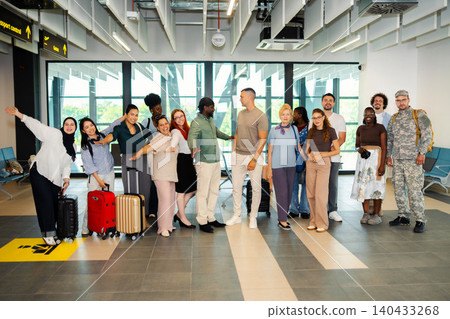 Diverse group of people standing in an airport terminal 140433268