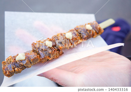 Skewered rice crackers with sauce, bought at Kurokawa Onsen. Skewered rice crackers with sauce, bought at Kurokawa Onsen. 140433316