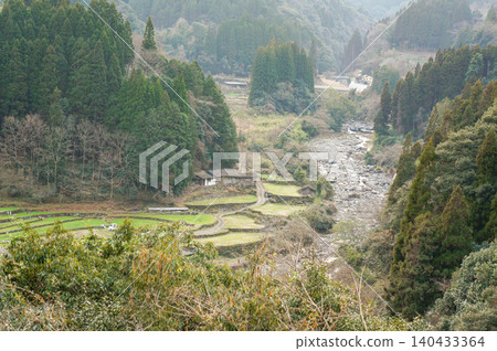 A tranquil rural landscape of terraced rice fields spread across the beautiful mountain valleys of Japan. A tranquil rural landscape of terraced rice fields spread across the beautiful mountain valleys of Japan. 140433364