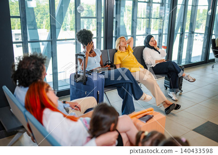 Travelers waiting in airport terminal experiencing many flight delays 140433598
