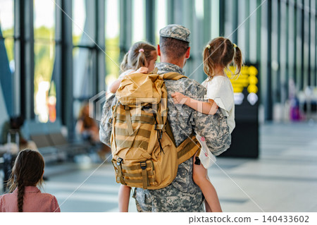Military father carrying children at airport homecoming return 140433602