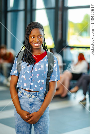 Young black student with backpack smiling on campus Young black student with backpack smiling on campus 140433617