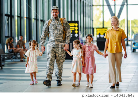 Soldier returning home with family at airport 140433642