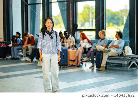 Young adult woman waiting in airport terminal for flight Young adult woman waiting in airport terminal for flight 140433652
