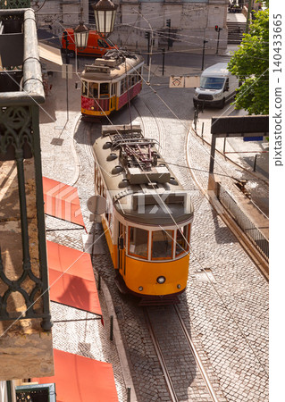 Historic Yellow Trams on Curved Street in Lisbon Portugal Historic Yellow Trams on Curved Street in Lisbon Portugal 140433665