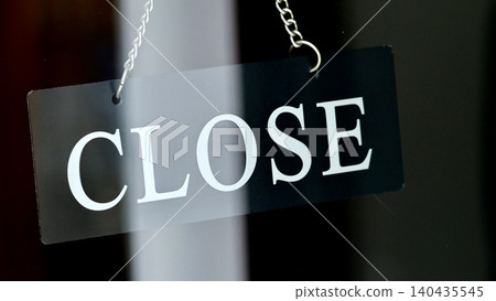 A stylish "closed" sign hanging at the entrance of a city cafe. A stylish "closed" sign hanging at the entrance of a city cafe. 140435545