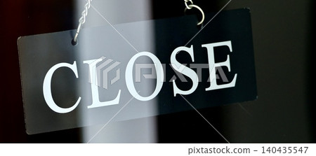 A stylish "closed" sign hanging at the entrance of a city cafe. A stylish "closed" sign hanging at the entrance of a city cafe. 140435547