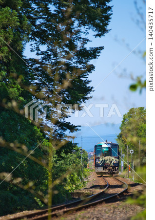 A local train running through fresh greenery A local train running through fresh greenery 140435717