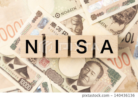 A block with "NISA" written on it and lots of 10,000 yen bills A block with "NISA" written on it and lots of 10,000 yen bills 140436136