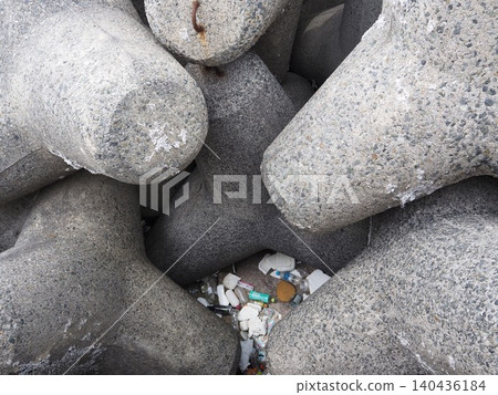 Plastic waste accumulated in breakwater blocks Plastic waste accumulated in breakwater blocks 140436184