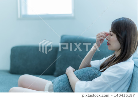The worries of a woman relaxing on the sofa The worries of a woman relaxing on the sofa 140436197