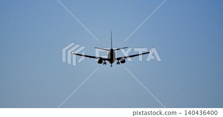 A simple scene of a plane's rear view as it prepares to land at the airport after a long journey. A simple scene of a plane's rear view as it prepares to land at the airport after a long journey. 140436400