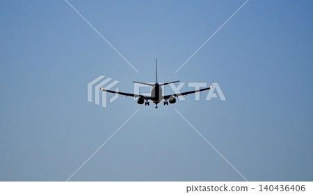 A simple scene of a plane's rear view as it prepares to land at the airport after a long journey. A simple scene of a plane's rear view as it prepares to land at the airport after a long journey. 140436406