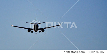 A simple scene of a plane's rear view as it prepares to land at the airport after a long journey. A simple scene of a plane's rear view as it prepares to land at the airport after a long journey. 140436407