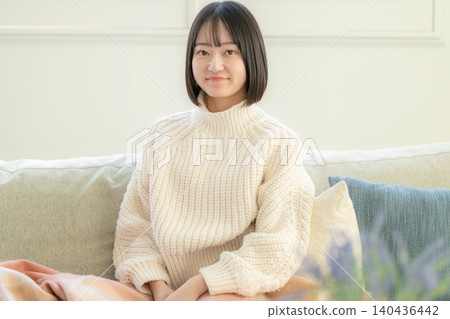 Young woman relaxing in a room Young woman relaxing in a room 140436442