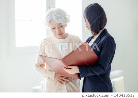 Senior woman talking to a salesman Senior woman talking to a salesman 140436532