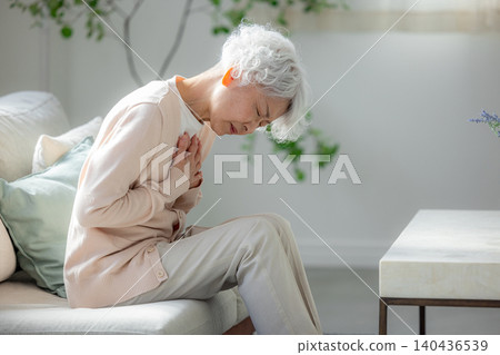 Senior woman suffering from heart palpitations 140436539