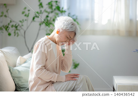 Senior women suffering from headache 140436542