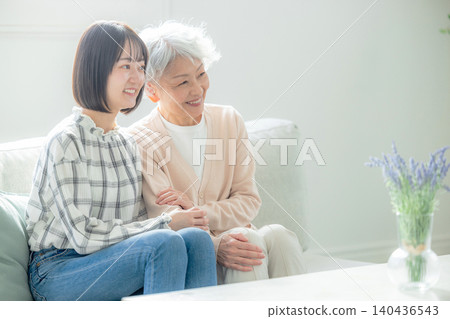 Grandmother and grandchild relaxing in the living room 140436543
