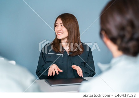 穿著工作服的女員工在辦公室工作 穿著工作服的女員工在辦公室工作 140437158