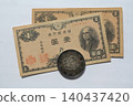 Japanese antique coins: 1 yen banknote and 1 yen silver coin 140437420