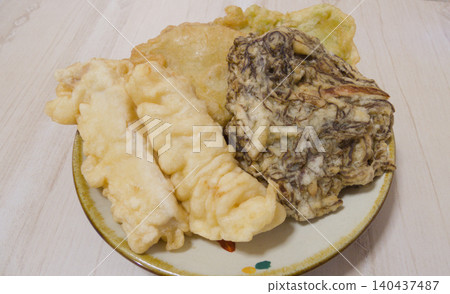 Okinawan Tempura Platter from Okujima Island | Enjoy local cuisine featuring fish, squid, mozuku seaweed, aosa seaweed, and sweet potato served on Yachimun pottery plates. Okinawan Tempura Platter from Okujima Island | Enjoy local cuisine featuring fish, squid, mozuku seaweed, aosa seaweed, and sweet potato served on Yachimun pottery plates. 140437487