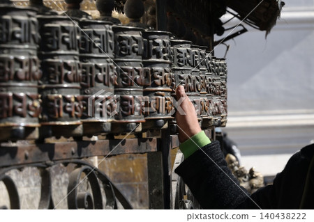 Turning the prayer wheel Turning the prayer wheel 140438222