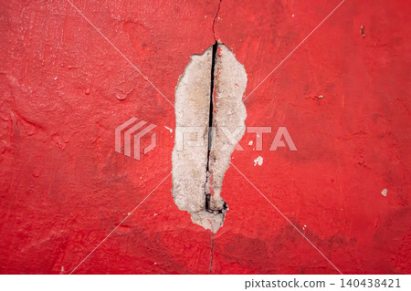 Cracked Red Painted Wall Texture with Exposed Concrete Background Cracked Red Painted Wall Texture with Exposed Concrete Background 140438421