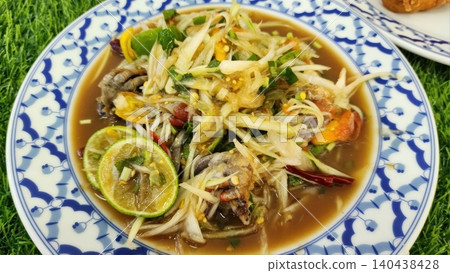Authentic Thai Papaya Salad with Fermented Fish Sauce and Lime on Plate Authentic Thai Papaya Salad with Fermented Fish Sauce and Lime on Plate 140438428