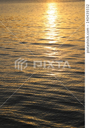 The setting sun sinking into the calm Seto Inland Sea and the sparkling sunlight beautifully reflected on the surface of the water. The setting sun sinking into the calm Seto Inland Sea and the sparkling sunlight beautifully reflected on the surface of the water. 140439332