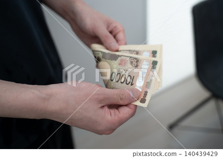 A woman counting money A woman counting money 140439429