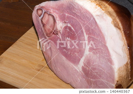 A large piece of HAM on a wooden background. 140440367