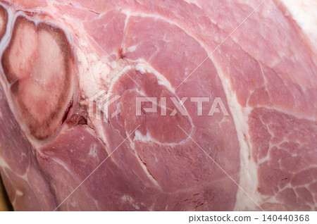 A large piece of HAM on a wooden background. 140440368