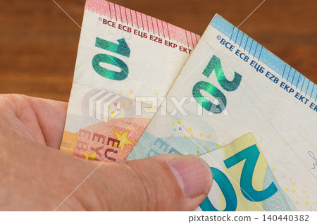 Close-up of 20 and 10 Euro banknotes in hand Close-up of 20 and 10 Euro banknotes in hand 140440382