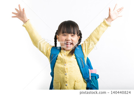 Excited Asian schoolgirl raising arms in celebration, back to school success concept. Excited Asian schoolgirl raising arms in celebration, back to school success concept. 140440824