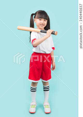 An Asian girl holding a baseball bat in both hands; a concept of children's sports and active play. 140440837