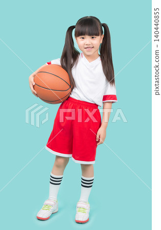 A full-body portrait of an Asian girl holding a basketball.kids sports and outdoor activity concept 140440855