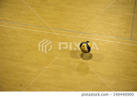 A volleyball lying on the gymnasium floor A volleyball lying on the gymnasium floor 140440900