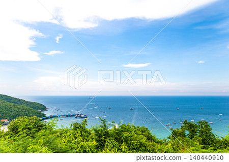 A beach surrounded by greenery and the blue sea. A beach surrounded by greenery and the blue sea. 140440910