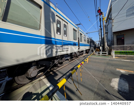 A train passing through a railroad crossing A train passing through a railroad crossing 140440937