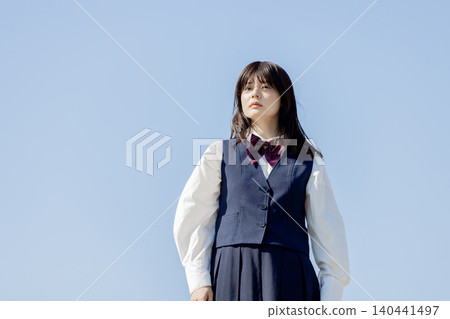 A high school girl gazes into the future against a backdrop of a blue sky. A high school girl gazes into the future against a backdrop of a blue sky. 140441497