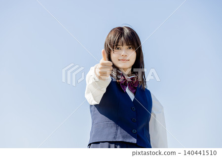 Portrait of a high school girl giving a thumbs-up in support. Portrait of a high school girl giving a thumbs-up in support. 140441510