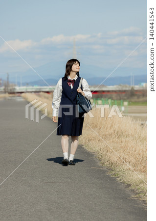 A high school girl walks her way to school, gazing into the future. A high school girl walks her way to school, gazing into the future. 140441543