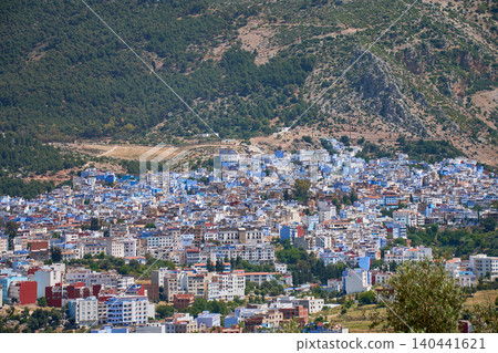 Panoramic view of the iconic blue city of Chefchaouen nestled in the mountainous foothills of Morocco Panoramic view of the iconic blue city of Chefchaouen nestled in the mountainous foothills of Morocco 140441621