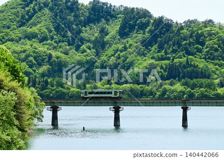 A diesel train crossing the full Kinshu Lake. A diesel train crossing the full Kinshu Lake. 140442066
