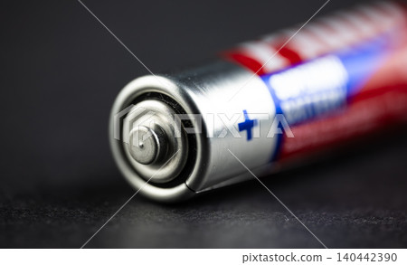 Extreme close-up of a household battery terminal showing the positive plus sign symbol Extreme close-up of a household battery terminal showing the positive plus sign symbol 140442390