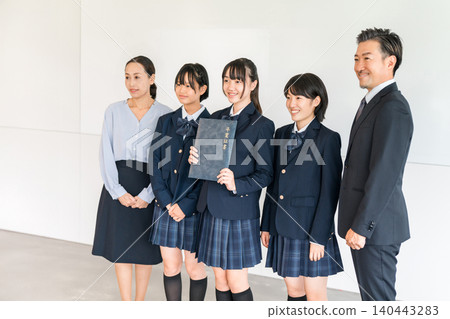Uniforms and blazers holding graduation certificates, elementary school and junior high school girls and male and female teachers 140443283