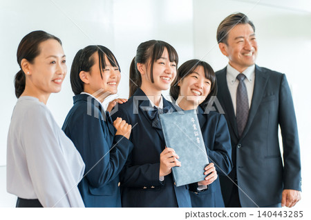 Uniforms and blazers holding graduation certificates, elementary school and junior high school girls and male and female teachers 140443285